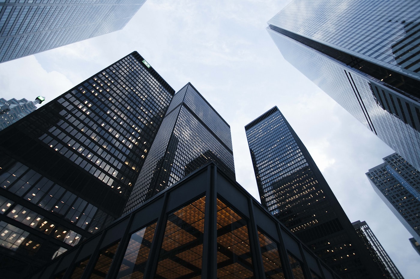 Glass office towers seen from street level, looking up