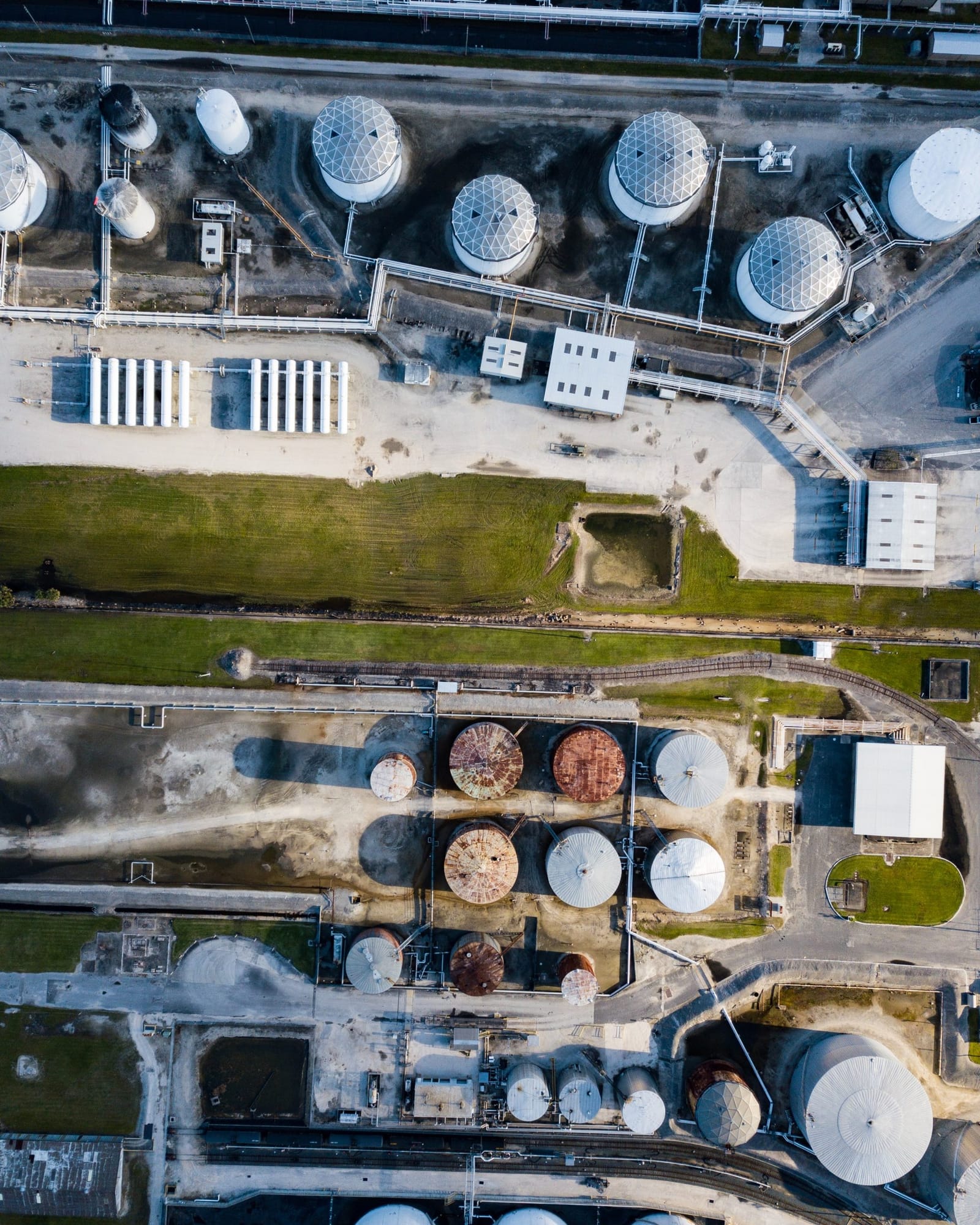Aerial view of a treatment plant with round digester tanks and clarifiers